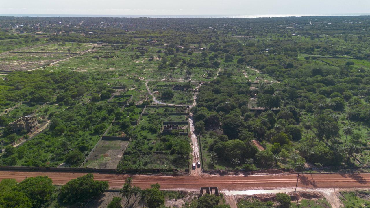 Aerial view of green land and access roads in The Gambia